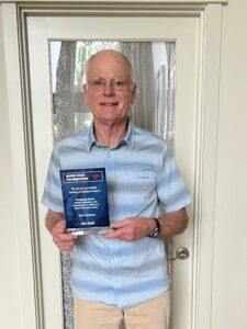 A Man Holding a Blue Trophy in Hand