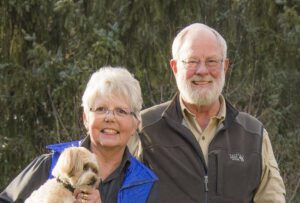 Two elderly people with their dog