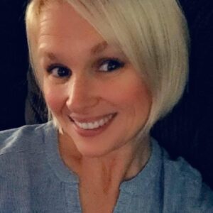 A blond-haired woman smiling