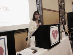 A Woman Speaking Behind a Podium