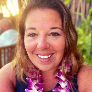 Kiley Wearing a Garland of Orchids and Smiling Image